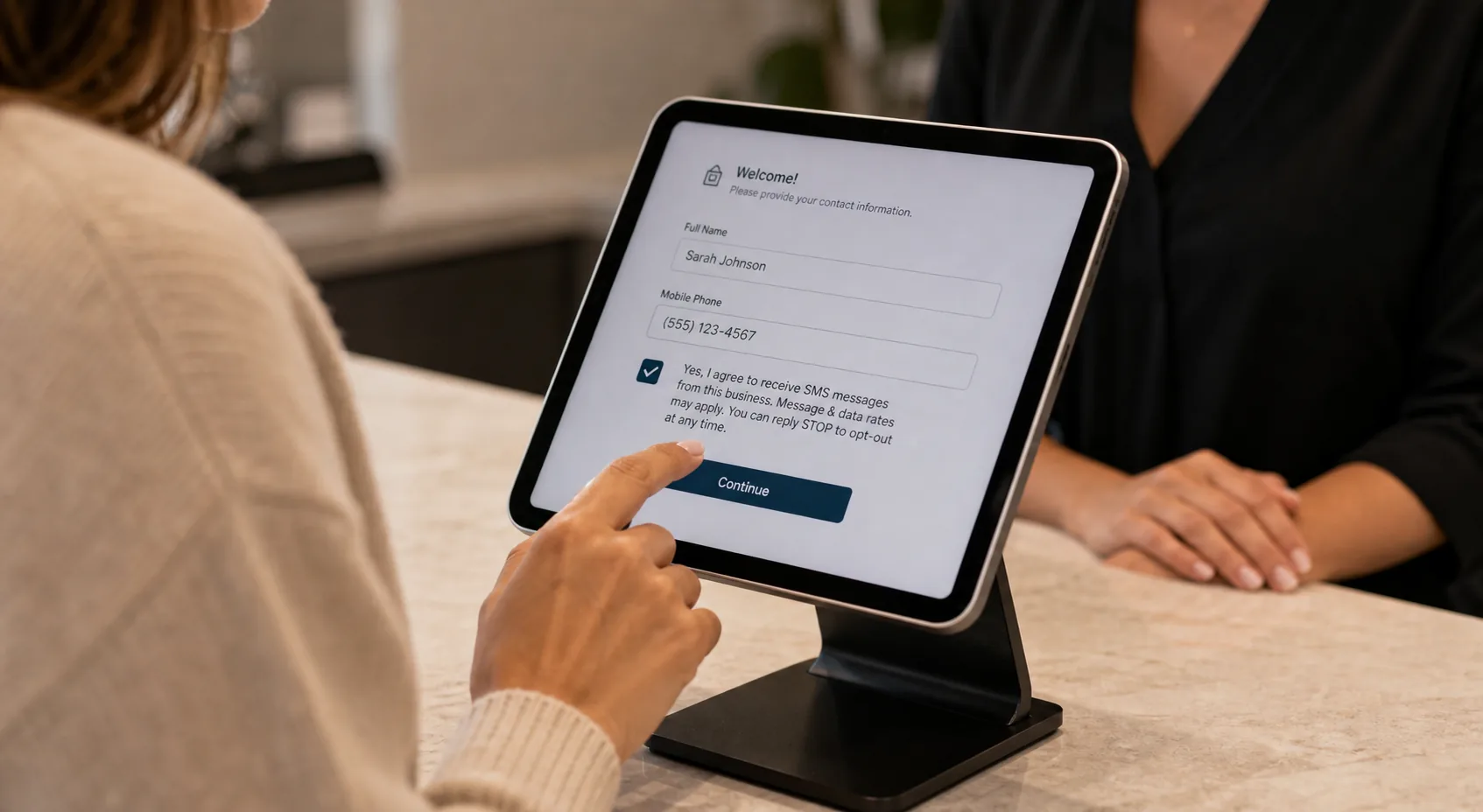 Paper salon intake form with a clearly visible SMS consent line and Reply STOP language directly under the phone number field